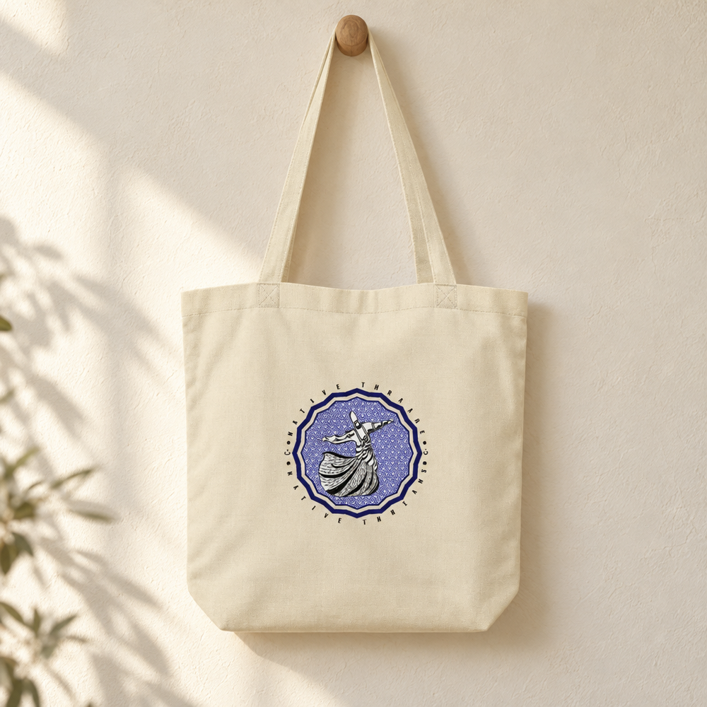 Dervish Hub Tote Bag, hanging from a wooden peg with the printed front visible.
