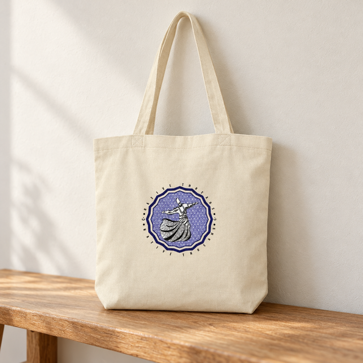 Dervish Hub Tote Bag, standing on a wooden bench with the printed front visible.