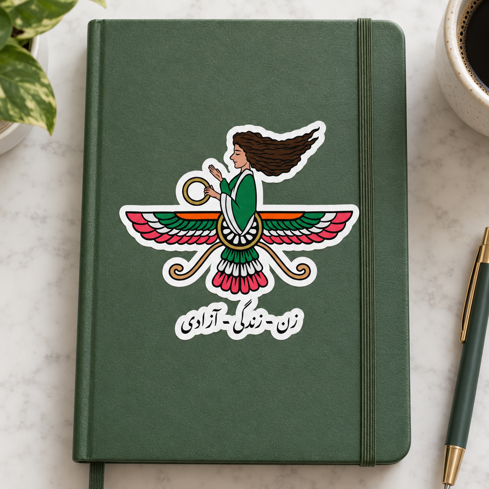 Iranian Farvahar Woman Life Freedom Sticker, applied to a plain notebook on a desk.