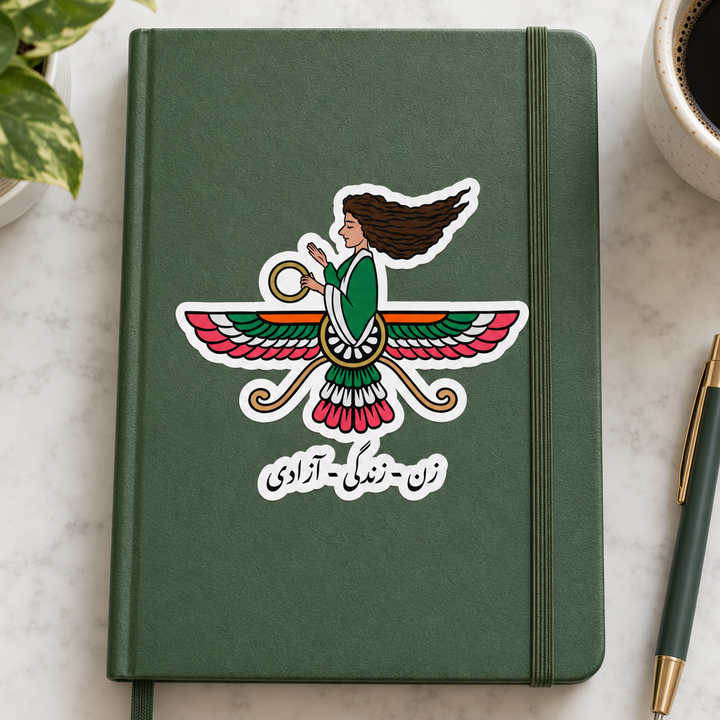 Iranian Farvahar Woman Life Freedom Sticker, applied to a plain notebook on a desk.