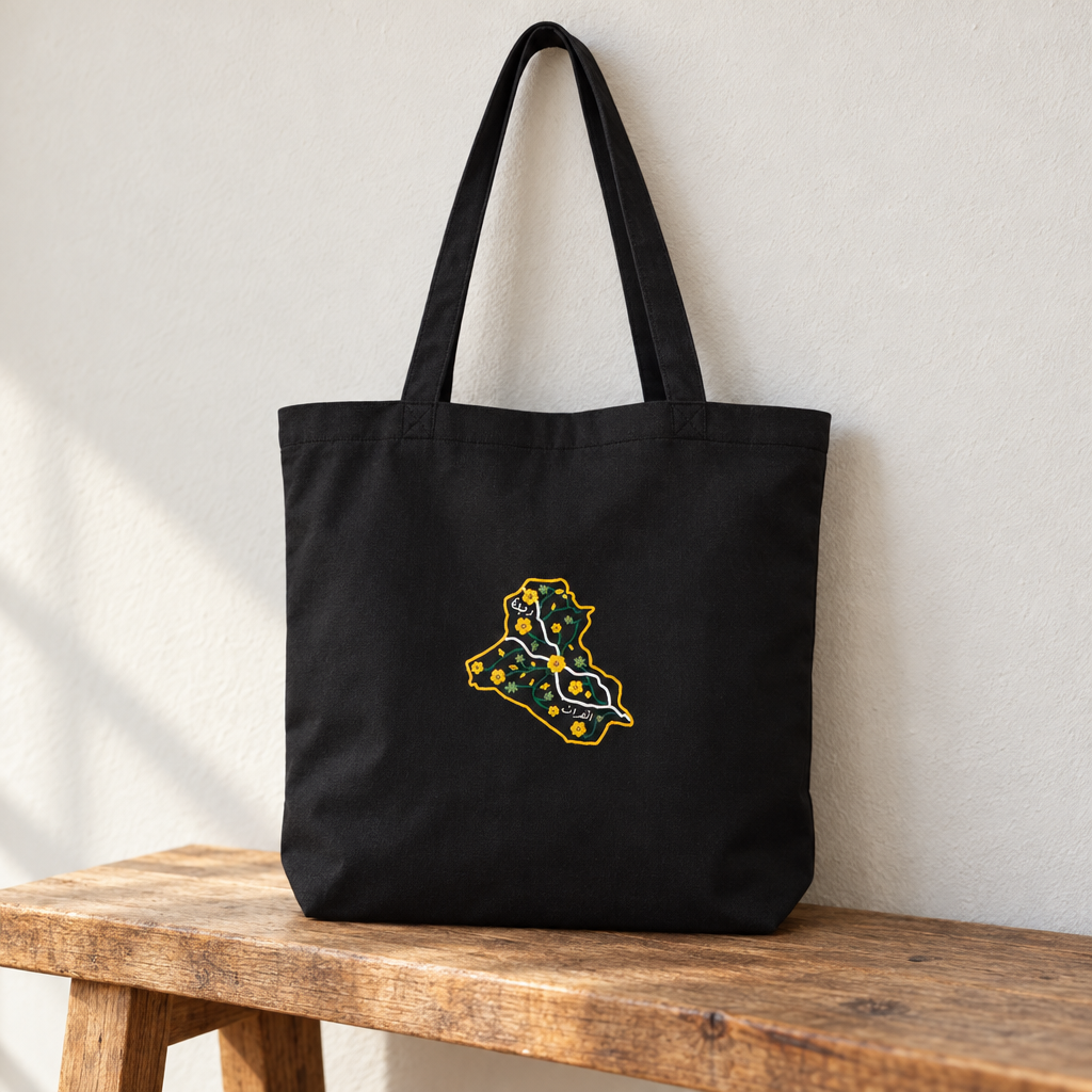 Iraq Tote Bag, standing on a wooden bench with the printed front visible.