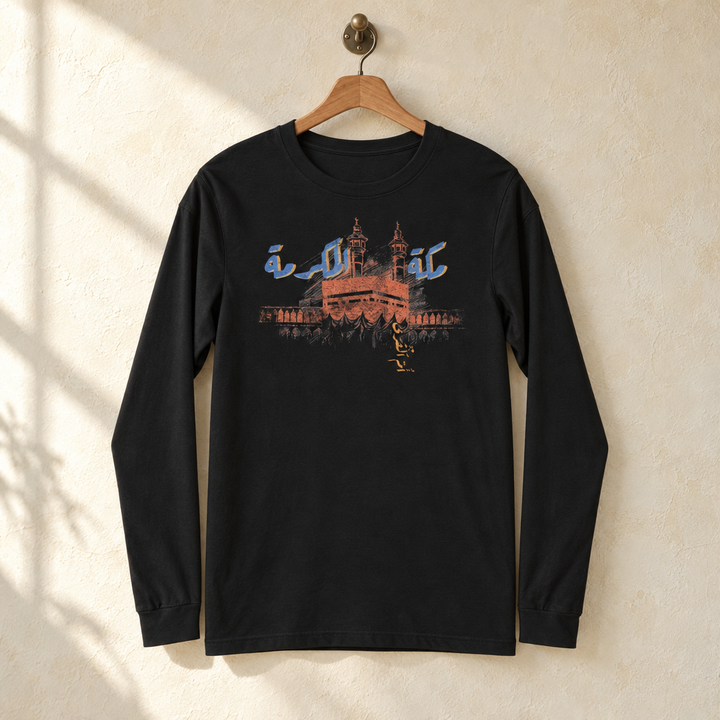 Makkah al-Mukarramah Long Sleeve, hanging on a wooden hanger against a pale wall.