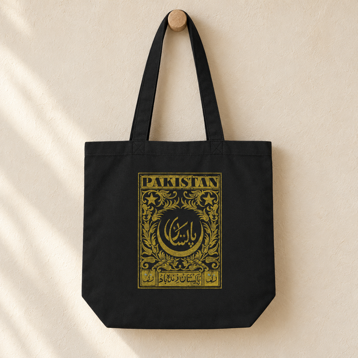 Pakistan Postcard Tote Bag, hanging from a wooden peg with the printed front visible.