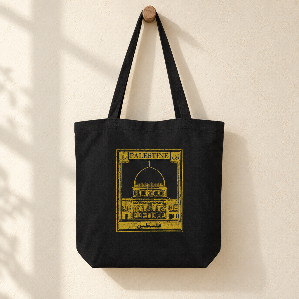 Palestine Postcard Tote Bag, hanging from a wooden peg with the printed front visible.
