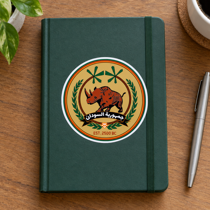 Sudan FC Sticker, applied to a plain notebook on a desk.