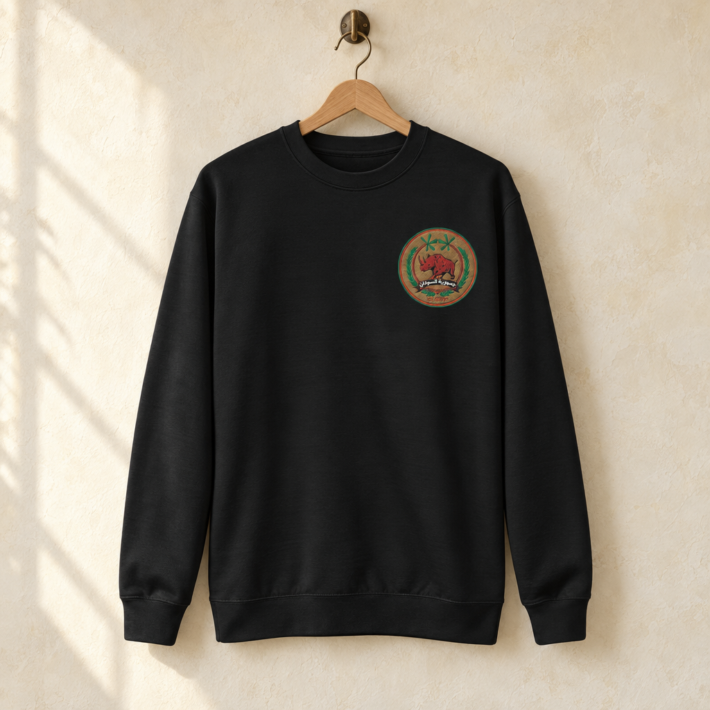 Sudan FC Sweater, hanging on a wooden hanger against a pale wall.