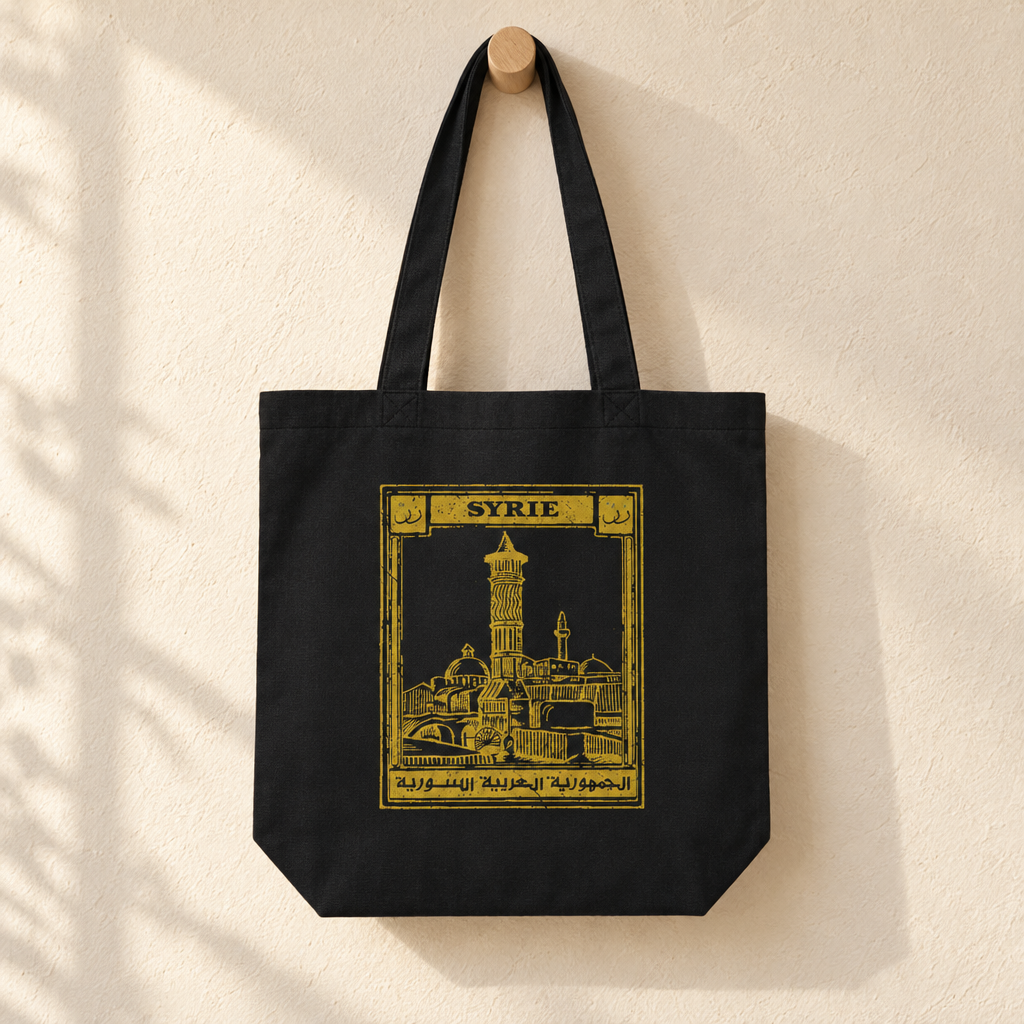 Syria Postcard Tote Bag, hanging from a wooden peg with the printed front visible.