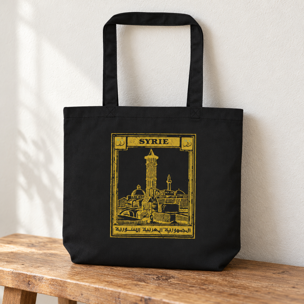Syria Postcard Tote Bag, standing on a wooden bench with the printed front visible.